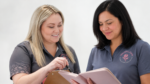 Two team members reviewing recruitment planning notes