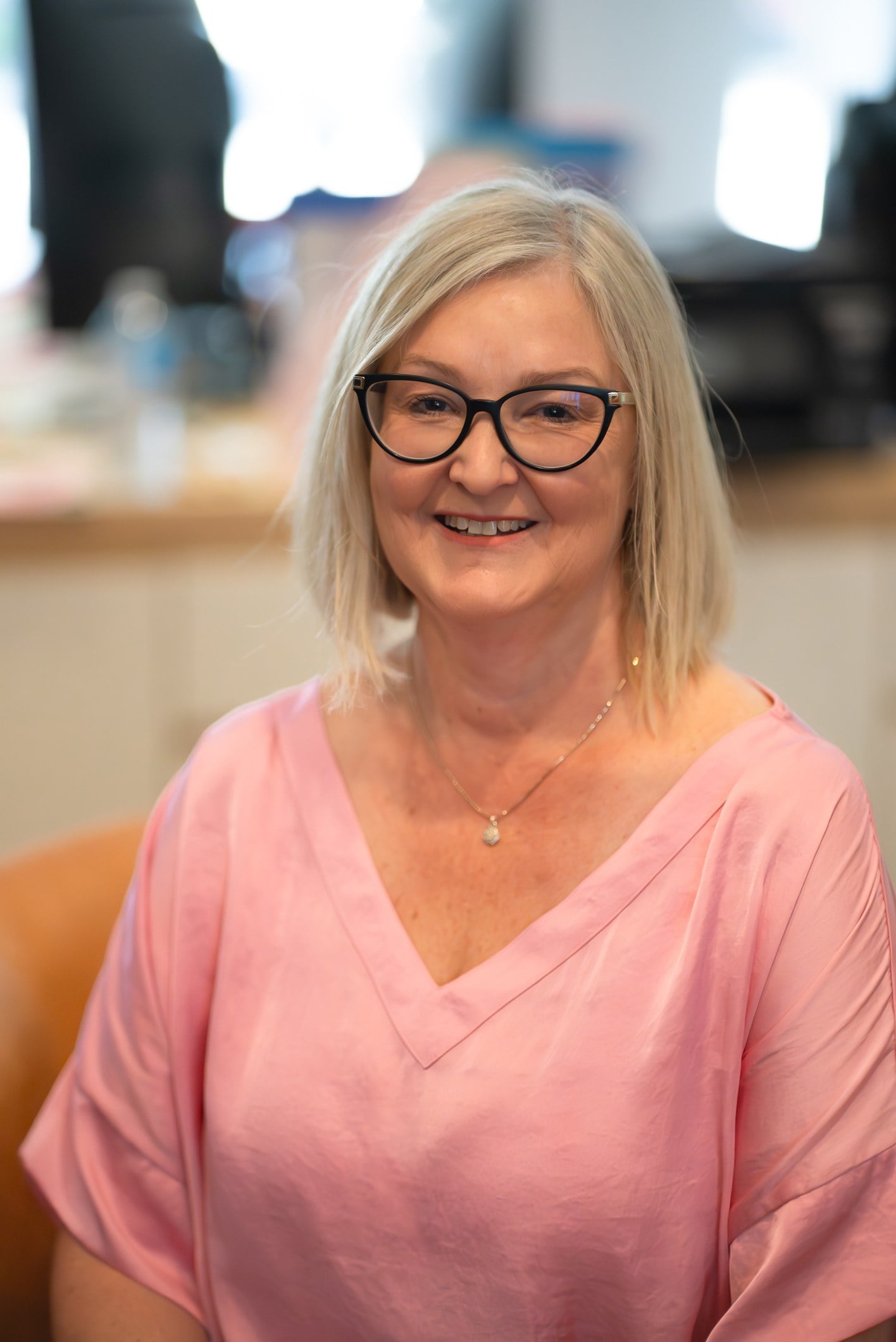 Belinda Beltz wearing a pink blouse