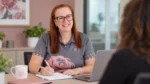 A member of The BelRose Group team taking notes during a conversation
