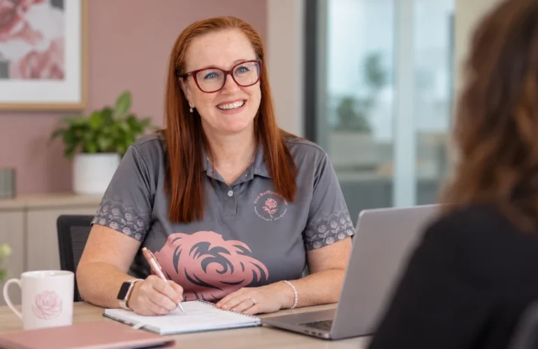 A member of The BelRose Group team taking notes during a conversation